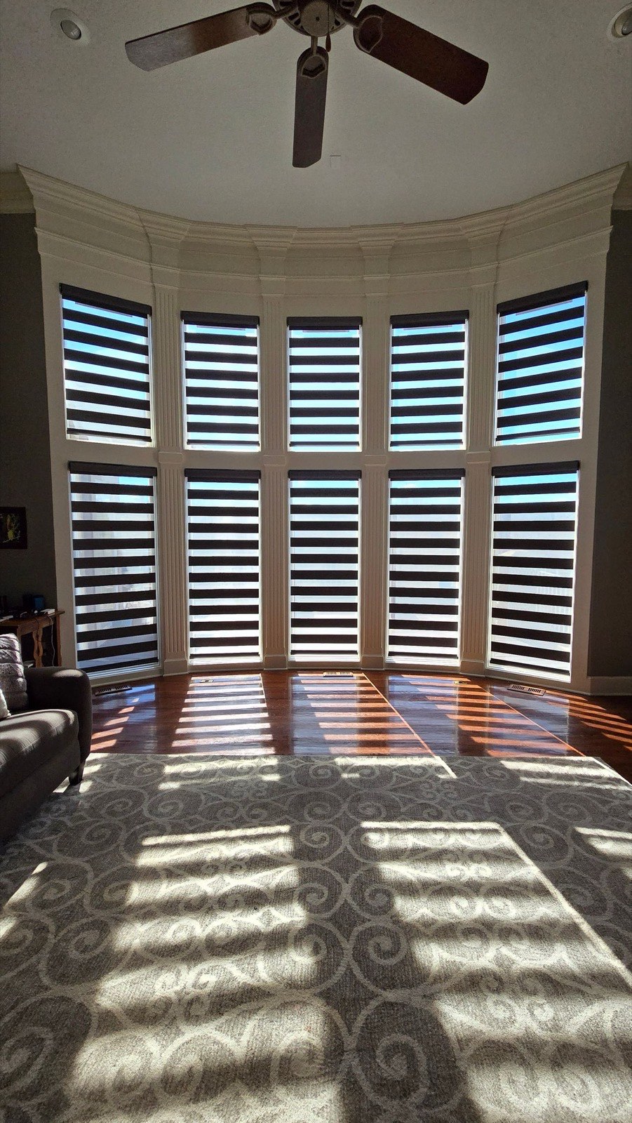 Banded shades on a curved bay window